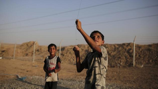 Seven year-old Omar from Mosul flies a kite in the Chamakor camp for displaced. Iraq’s Sunni Arabs generally estimated at 15 to 20% of Iraq’s 37 million people find themselves at a crossroad after 3 years of war to free them from ISIS rule. Vast numbers displaced from their communities are unsure what their place will be in Iraq’s future with the Shiites and the Kurds aiming to alter the demographics of some Sunni areas to impose their own control. (Bram Janssen / AP) Seven year-old Omar from Mosul flies a kite in the Chamakor camp for displaced. Iraq’s Sunni Arabs generally estimated at 15 to 20% of Iraq’s 37 million people find themselves at a crossroad after 3 years of war to free them from ISIS rule. Vast numbers displaced from their communities are unsure what their place will be in Iraq’s future with the Shiites and the Kurds aiming to alter the demographics of some Sunni areas to impose their own control. (Bram Janssen / AP)