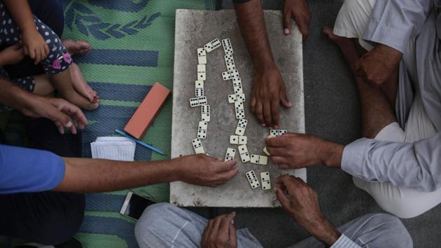 Sunni Arabs play a game of dominoes in the Hassan Sham camp in northern Iraq. Kurdish officials cite security reasons for not allowing residents back even though IS was driven out of the area late last year. At the same time, the Kurds have repeatedly said they intend to incorporate the captured territory into a self-rule zone — even as they plan a referendum for outright independence later this month. This raises questions over the future of Sunni Arab villages like Hassan Sham. (Bram Janssen / AP) Sunni Arabs play a game of dominoes in the Hassan Sham camp in northern Iraq. Kurdish officials cite security reasons for not allowing residents back even though IS was driven out of the area late last year. At the same time, the Kurds have repeatedly said they intend to incorporate the captured territory into a self-rule zone — even as they plan a referendum for outright independence later this month. This raises questions over the future of Sunni Arab villages like Hassan Sham. (Bram Janssen / AP)