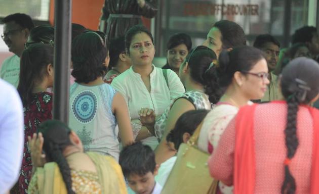 Parents wait outside a school in Lucknow at dispersal time. (HT Photo) Parents wait outside a school in Lucknow at dispersal time. (HT Photo)
