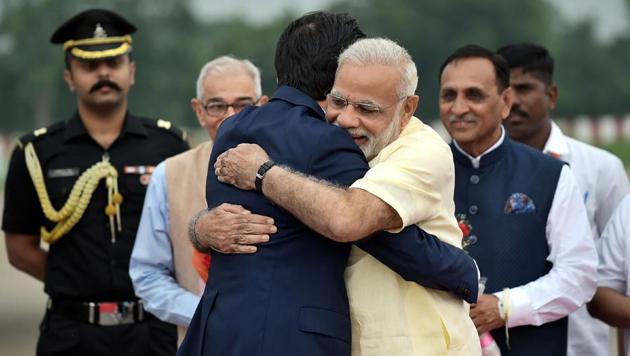 Prime Minister Narendra Modi hugs Japanese prime minister Shinzo Abe at the Ahmedabad airport.(AFP/PIB)