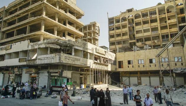 People wait for a bus in Aleppo, Syria, Tuesday, Sept. 12, 2017. The recapture of eastern Aleppo in December 2016, one of the deadliest episodes of the Syrian civil war, was a landmark victory for Assad's forces in the conflict, now in its seventh year, but it left the area in ruins. (AP) People wait for a bus in Aleppo, Syria, Tuesday, Sept. 12, 2017. The recapture of eastern Aleppo in December 2016, one of the deadliest episodes of the Syrian civil war, was a landmark victory for Assad's forces in the conflict, now in its seventh year, but it left the area in ruins. (AP)