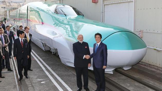 Prime Minister Narendra Modi and his Japanese counterpart Shinzo Abe shaking hands in front of a Shinkansen train during their inspection of a bullet train manufacturing plant in Kobe, Hyogo prefecture.(AFP) Prime Minister Narendra Modi and his Japanese counterpart Shinzo Abe shaking hands in front of a Shinkansen train during their inspection of a bullet train manufacturing plant in Kobe, Hyogo prefecture.(AFP)