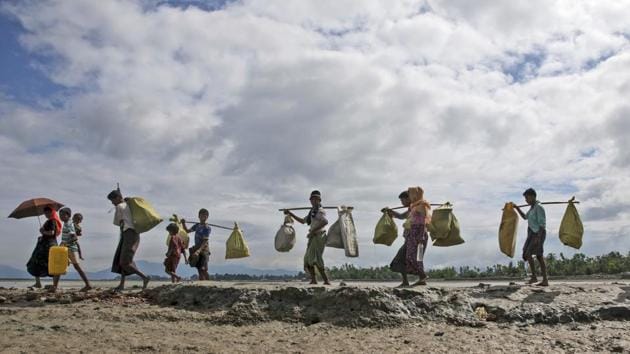 Rohingya Muslims, who crossed over from Myanmar into Bangladesh, walk towards a refugee camp in Shah Porir Dwip, Bangladesh. (AP) Rohingya Muslims, who crossed over from Myanmar into Bangladesh, walk towards a refugee camp in Shah Porir Dwip, Bangladesh. (AP)