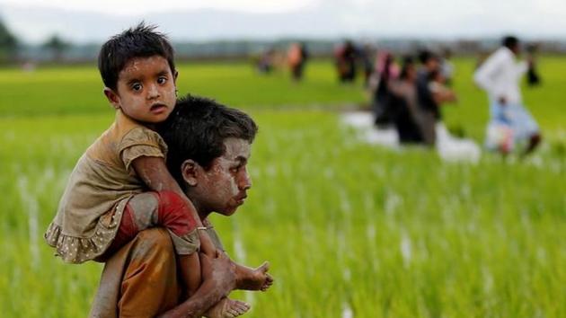A Rohingya boy carries a child after crossing the Bangladesh-Myanmar border in Teknaf, Bangladesh, on September 1, 2017.(Reuters Photo)