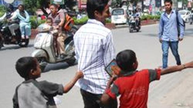 Child beggars seeks alms from a passer-by.(HT File Photo)