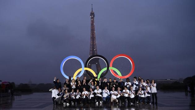 Volunteers pose in front of the Olympics Rings on the Trocadero Esplanade near the Eiffel Tower in Paris, on September 13, 2017. (AFP) Volunteers pose in front of the Olympics Rings on the Trocadero Esplanade near the Eiffel Tower in Paris, on September 13, 2017. (AFP)