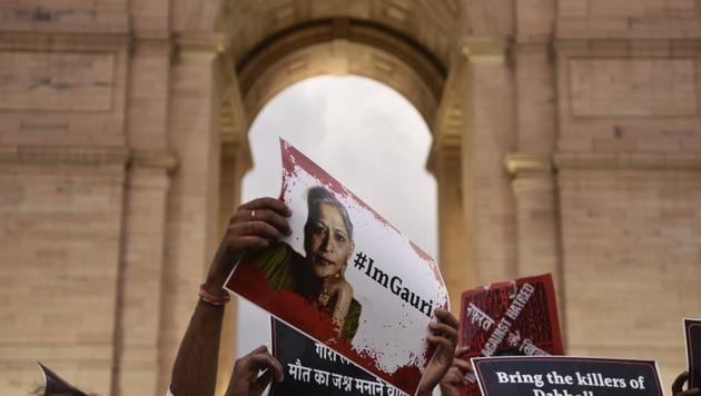 A protester holds a placard at a candle light vigil organised for Gauri Lankesh at India Gate, New Delhi, on September 6.(Burhaan Kinu/ HT)