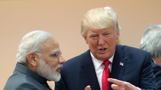 US President Donald Trump (R) talks with Narendra Modi as they attend a working session during the G20 summit in Hamburg, northern Germany, on July 8, 2017.(AFP File Photo)