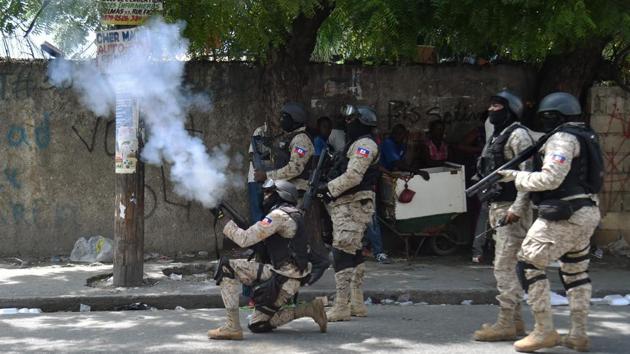 Haitian police fire tear gas to disperse protesters during an anti-government demonstration in the centre Port-au-Prince. Protesters took to the streets in separate groups, erecting flaming barricades, blocking traffic, and confronting riot police, who fired tear gas and warning shots in the air. (Hector Retamal / AFP) Haitian police fire tear gas to disperse protesters during an anti-government demonstration in the centre Port-au-Prince. Protesters took to the streets in separate groups, erecting flaming barricades, blocking traffic, and confronting riot police, who fired tear gas and warning shots in the air. (Hector Retamal / AFP)