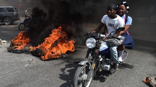 Protesters brought parts of the Haitian capital Port-au-Prince to a standstill, setting vehicles alight and damaging local businesses in violent demonstrations against the government’s 2017-18 budget plans. Demonstrators took to the streets, throwing stones at the police, setting tires on fire and blocking some streets at a time when foreign aid is declining. (Hector Retamal / AFP) Protesters brought parts of the Haitian capital Port-au-Prince to a standstill, setting vehicles alight and damaging local businesses in violent demonstrations against the government’s 2017-18 budget plans. Demonstrators took to the streets, throwing stones at the police, setting tires on fire and blocking some streets at a time when foreign aid is declining. (Hector Retamal / AFP)