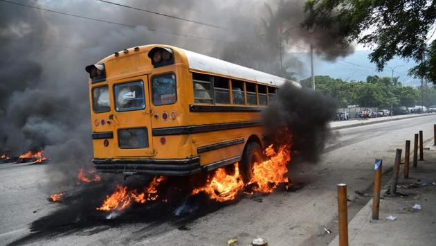A bus with passengers aboard drives over burning tires placed by demonstrators. At the same time, foreign aid to Haiti is slowing. The country is one of the poorest in the Americas and suffered a devastating earthquake in 2010 and the worst of hurricane Matthew last year. ‘If Jovenel Moise is intelligent, he should refrain from publishing the budget, otherwise he will have to face a series of street demonstrations that will further complicate the situation,’ Jean-Charles Moise said on local radio. (Hector Retamal / AFP) A bus with passengers aboard drives over burning tires placed by demonstrators. At the same time, foreign aid to Haiti is slowing. The country is one of the poorest in the Americas and suffered a devastating earthquake in 2010 and the worst of hurricane Matthew last year. ‘If Jovenel Moise is intelligent, he should refrain from publishing the budget, otherwise he will have to face a series of street demonstrations that will further complicate the situation,’ Jean-Charles Moise said on local radio. (Hector Retamal / AFP)