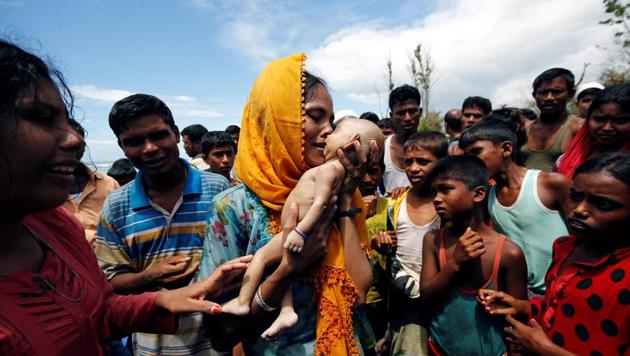 Hamida, a Rohingya refugee woman cries as she holds her 40-day-old son, who died as a boat capsized in the shore of Shah Porir Dwip, in Teknaf, Bangladesh, on Thursday. (REUTERS) Hamida, a Rohingya refugee woman cries as she holds her 40-day-old son, who died as a boat capsized in the shore of Shah Porir Dwip, in Teknaf, Bangladesh, on Thursday. (REUTERS)
