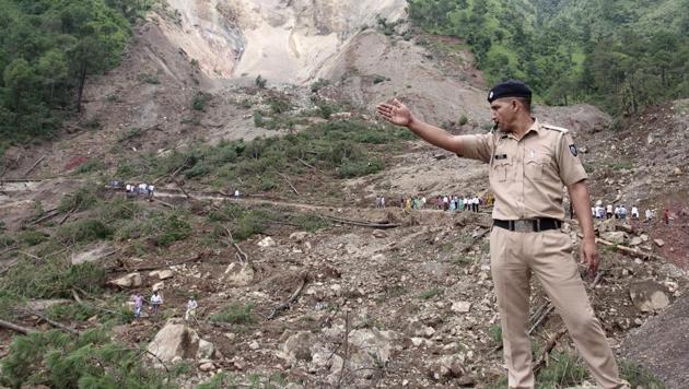 A policeman gestures at the site of a landslide on August 14 in Himachal Pradesh. (AFP File Photo) A policeman gestures at the site of a landslide on August 14 in Himachal Pradesh. (AFP File Photo)