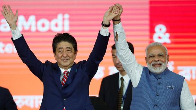 Japanese Prime Minister Shinzo Abe (L) and his Indian counterpart Narendra Modi raise hands after the groundbreaking ceremony for a high-speed rail project in Ahmedabad on Thursday. (REUTERS) Japanese Prime Minister Shinzo Abe (L) and his Indian counterpart Narendra Modi raise hands after the groundbreaking ceremony for a high-speed rail project in Ahmedabad on Thursday. (REUTERS)