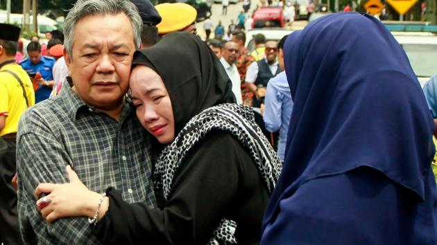 Nik Azlan Nik Abdul Kadir (L), father of one of the victims comforts his wife outside the Darul Quran Ittifaqiyah religious school in Kuala Lumpur . (SADIQ ASYRAF / AFP) Nik Azlan Nik Abdul Kadir (L), father of one of the victims comforts his wife outside the Darul Quran Ittifaqiyah religious school in Kuala Lumpur . (SADIQ ASYRAF / AFP)