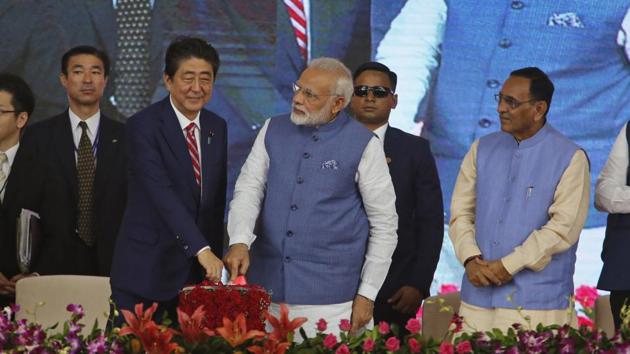 Prime Minister Narendra Modi and his Japanese Japanese counterpart Shinzo Abe press a button to launch a high speed rail project in Ahmadabad on Thursday(AP Photo)
