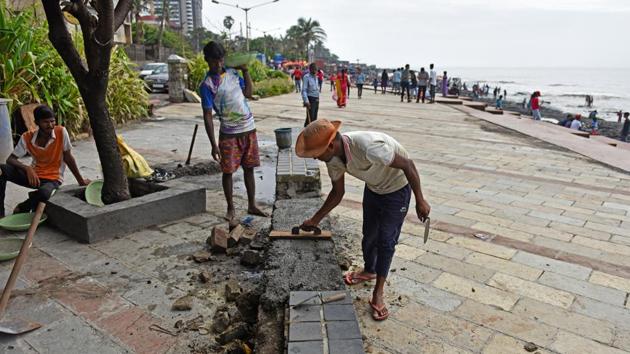 Workers repair promenade at Bandstand in Mumbai on Wednesday. (Satyabrata Tripathy/HT Photo) Workers repair promenade at Bandstand in Mumbai on Wednesday. (Satyabrata Tripathy/HT Photo)