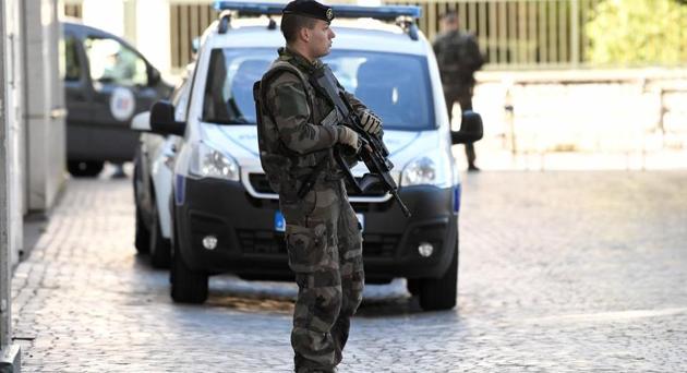 An armed French soldier stands near the site where a car slammed into soldiers on patrol in Levallois-Perret, outside Paris. (AFP File Photo) An armed French soldier stands near the site where a car slammed into soldiers on patrol in Levallois-Perret, outside Paris. (AFP File Photo)