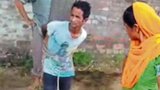 A screenshot from a video showing Tikka Masih tied to a tree. (Courtesy: Sunita Masih) A screenshot from a video showing Tikka Masih tied to a tree. (Courtesy: Sunita Masih)
