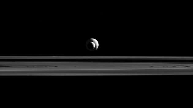 Like a cosmic bull’s-eye, Enceladus and Tethys line up almost perfectly for Cassini’s cameras. Since the two moons are not only aligned, but also at relatively similar distances from Cassini, the apparent sizes in this image are a good approximation of the relative sizes of Enceladus (313 miles or 504 kilometers across) and Tethys (660 miles or 1,062 kilometers across). (NASA/JPL-Caltech) 