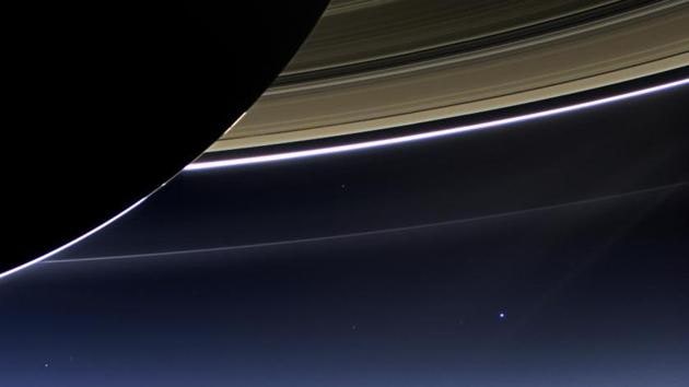 In this rare image taken on July 19, 2013, the wide-angle camera on Cassini spacecraft has captured Saturn’s rings and our planet Earth and its moon in the same frame. This is the only wide-angle footprint that has the Earth-moon system in it. Earth, which is 898 million miles (1.44 billion kilometers) away in this image, appears as a blue dot at center right.  (NASA/JPL-Caltech/Space Science Institute) 