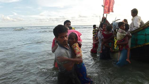 Rohingya refugees disembark from a boat after crossing the border from Myanmar, on the Bangladeshi shores of the Naf river in Teknaf on Thursday. (AFP) Rohingya refugees disembark from a boat after crossing the border from Myanmar, on the Bangladeshi shores of the Naf river in Teknaf on Thursday. (AFP)