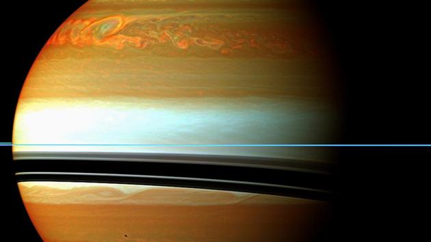 NASA’s Cassini spacecraft has tracked the aftermath of a rare massive storm on Saturn. These red, orange and green clouds (false colour) in Saturn’s northern hemisphere indicate the tail end of the massive 2010-2011 storm.  (NASA/JPL-Caltech) 