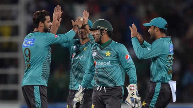 Pakistan cricket team players celebrate during their Independence Cup T20 match against ICC World XI at the Gaddafi Cricket Stadium in Lahore. (AFP)