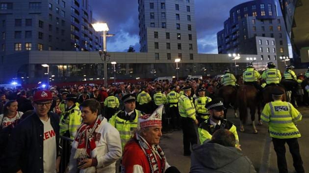 Police guard the stadium entrances as the kick off is delayed due to crowd safety issues ahead of the UEFA Europa League Group H football match between Arsenal and FC Cologne.(AFP)