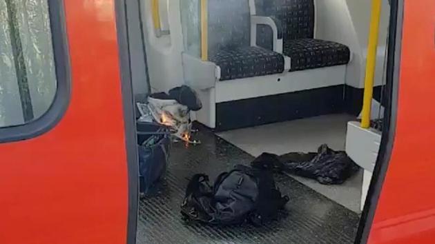 Unverified photos taken inside a District Line train show a white plastic bucket inside a supermarket shopping bag. Flames and what appear to be wires can be seen. Police say it’s ‘too early to confirm the cause of the fire, which will be subject to the investigation that is now underway by the Met’s Counter Terrorism Command.’ (Sylvain Pennec / REUTERS)