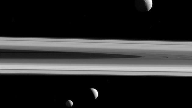 The three of Saturn's moons - Tethys (above), Enceladus (second left), and Mimas, seen from the Cassini spacecraft. (NASA/JPL-Caltech/Space Science Institute/AP) 