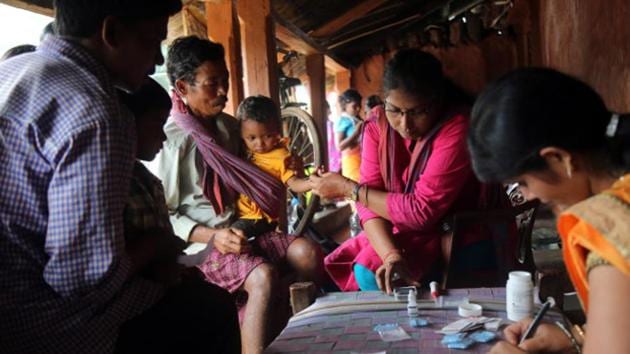 A health worker taking the blood sample of a child at mass screening for malaria at Budabirmaha. Children below five were also screening for anaemia and stunting during the screening.(IndiaSpend) A health worker taking the blood sample of a child at mass screening for malaria at Budabirmaha. Children below five were also screening for anaemia and stunting during the screening.(IndiaSpend)