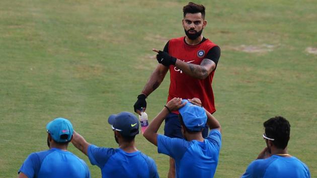 Virat Kohli interacts with teammates during a training session ahead of the India-Australia series. (AFP) Virat Kohli interacts with teammates during a training session ahead of the India-Australia series. (AFP)
