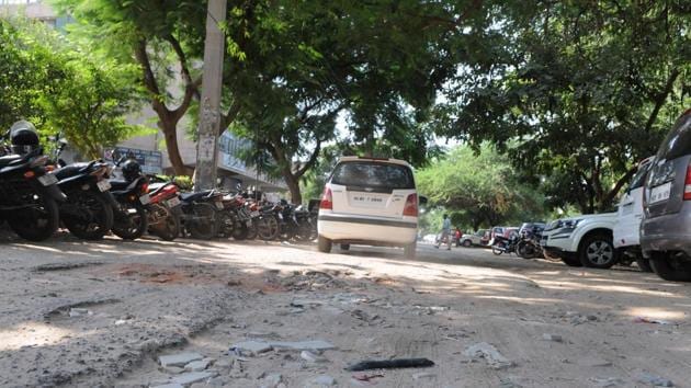 Roads in DLF Phase-1, which is part of ward 34, are badly damaged near Qutub Plaza market. (Parveen Kumar/HT PHOTO) Roads in DLF Phase-1, which is part of ward 34, are badly damaged near Qutub Plaza market. (Parveen Kumar/HT PHOTO)