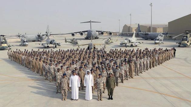 In a September released photo by the Qatar News Agency, the Qatari Emir Sheikh Tamim bin Hamad Al Thani (centre front) poses for a photo with Emiri Air Force at al-Udeid Air Base in Doha, Qatar. (AP File Photo) In a September released photo by the Qatar News Agency, the Qatari Emir Sheikh Tamim bin Hamad Al Thani (centre front) poses for a photo with Emiri Air Force at al-Udeid Air Base in Doha, Qatar. (AP File Photo)
