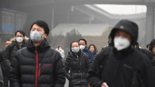 This December 20, 2016 file photo shows commuters wearing masks on a polluted day in Beijing.(AFP File Photo)