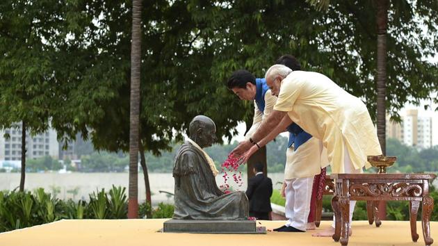 This handout photograph released by India's Press Information Bureau (PIB) on September 13, 2017, shows Prime Minister Narendra Modi (R), Japanese Prime Minister Shinzo Abe (L) and Abe's wife Akie (unseen) paying tribute to Mahatma Gandhi at Sabarmati Ashram, in Ahmedabad. (PIB / AFP) This handout photograph released by India's Press Information Bureau (PIB) on September 13, 2017, shows Prime Minister Narendra Modi (R), Japanese Prime Minister Shinzo Abe (L) and Abe's wife Akie (unseen) paying tribute to Mahatma Gandhi at Sabarmati Ashram, in Ahmedabad. (PIB / AFP)