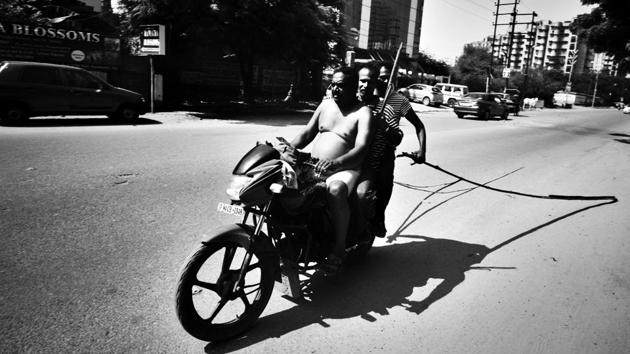 Most workers come to work and leave together, with the tools of their trade often hanging behind their cycles or bikes as they make their way back home. (Ravi Choudhary / HT Photo)