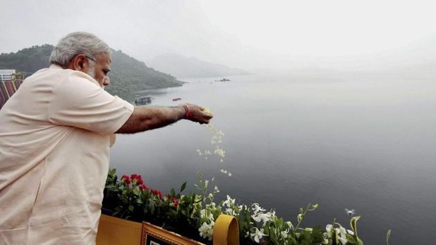 Prime Minister Narendra Modi offers prayers to Narmada River during the inauguration of Sardar Sarovar Dam at Kevadiya in Narmada district on Sunday. (PTI) Prime Minister Narendra Modi offers prayers to Narmada River during the inauguration of Sardar Sarovar Dam at Kevadiya in Narmada district on Sunday. (PTI)