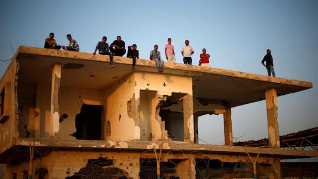 Palestinians gather atop a damaged building as they wait for the return of their relatives after performing the annual Haj pilgrimage in Mecca, at Rafah border crossing, in the southern Gaza Strip September 13, 2017. (Mohammed Salem / Reuters) Palestinians gather atop a damaged building as they wait for the return of their relatives after performing the annual Haj pilgrimage in Mecca, at Rafah border crossing, in the southern Gaza Strip September 13, 2017. (Mohammed Salem / Reuters)