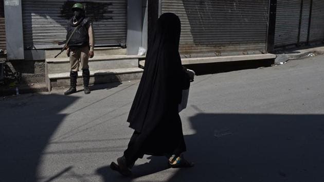 An Indian paramilitary trooper stands guard as a Kashmiri woman walks near the Jamia Masjid mosque in Srinagar on September 15, 2017. The Government on Friday imposed travel restrictions in parts of Srinagar and closed educational institutions in the region to prevent the protests against the killing of two Lashkar-e-Taiba militants including top commander Abu Ismail. (Tauseef Mustafa / AFP) An Indian paramilitary trooper stands guard as a Kashmiri woman walks near the Jamia Masjid mosque in Srinagar on September 15, 2017. The Government on Friday imposed travel restrictions in parts of Srinagar and closed educational institutions in the region to prevent the protests against the killing of two Lashkar-e-Taiba militants including top commander Abu Ismail. (Tauseef Mustafa / AFP)