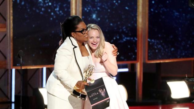 Oprah Winfrey embraces Elizabeth Moss as she presents The Handmaid's Tale with the award for Outstanding Drama Series. (REUTERS)