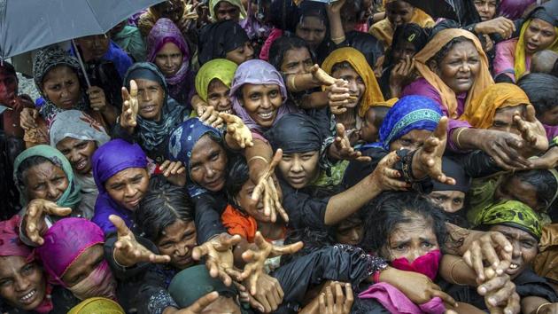 Rohingya Muslim women, who crossed over from Myanmar into Bangladesh, stretch their arms out to collect sanitary products distributed by aid agencies near Balukhali refugee camp, Bangladesh. (AP Photo) Rohingya Muslim women, who crossed over from Myanmar into Bangladesh, stretch their arms out to collect sanitary products distributed by aid agencies near Balukhali refugee camp, Bangladesh. (AP Photo)