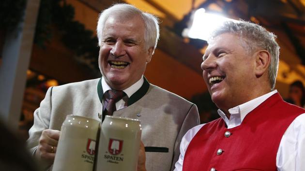 Dieter Reiter, Mayor of Munich(R), started the Oktoberfest by tapping the first barrel of beer in the Schottenhamel tent. He drove the tap into the barrel with just 2 strikes this year, concluding the ceremony with the magic words: ‘O’zapft is!’ - ‘It’s tapped!’ The first mug of beer was then handed to the Bavarian Prime Minister, Horst Seehofer. (Michaela Rehle / Reuters) Dieter Reiter, Mayor of Munich(R), started the Oktoberfest by tapping the first barrel of beer in the Schottenhamel tent. He drove the tap into the barrel with just 2 strikes this year, concluding the ceremony with the magic words: ‘O’zapft is!’ - ‘It’s tapped!’ The first mug of beer was then handed to the Bavarian Prime Minister, Horst Seehofer. (Michaela Rehle / Reuters)