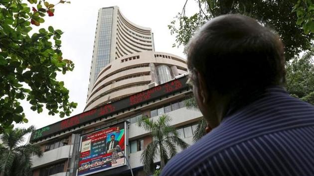 A man looks at a screen across a road displaying the Sensex on the facade of the Bombay Stock Exchange building in Mumbai. (Reuters File Photo) A man looks at a screen across a road displaying the Sensex on the facade of the Bombay Stock Exchange building in Mumbai. (Reuters File Photo)