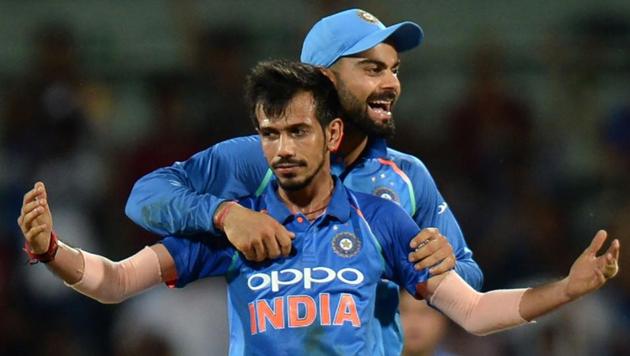 Indian cricketer Yuzvendra Chahal celebrates the wicket of Australian cricketer Glenn Maxwell with captain Virat Kohli during the first One-Day International at the MA Chidhambaram Stadium in Chennai on Sunday.(AFP)