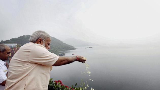 Prime Minister Narendra Modi offers prayers to Narmada River during the inauguration of Sardar Sarovar Dam at Kevadiya in Narmada district on Sunday. (PTI Photo) Prime Minister Narendra Modi offers prayers to Narmada River during the inauguration of Sardar Sarovar Dam at Kevadiya in Narmada district on Sunday. (PTI Photo)