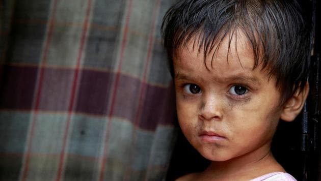 A child from the Rohingya community stands outside a shack in a camp in New Delhi.(Reuters file)