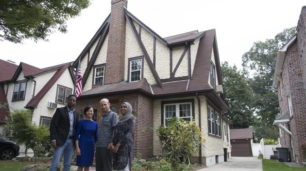 Abdi Iftin (L) of Somalia, Uyen Nguyen of Vietnam (2nd from L), Eiman Ali of Somalia (R0 and Ghassan al-Chahada of Syria pose for a photo outside US President Donald Trump's boyhood home in the Jamaica Estates neighbourhood of the Queens borough of New York. (AP) Abdi Iftin (L) of Somalia, Uyen Nguyen of Vietnam (2nd from L), Eiman Ali of Somalia (R0 and Ghassan al-Chahada of Syria pose for a photo outside US President Donald Trump's boyhood home in the Jamaica Estates neighbourhood of the Queens borough of New York. (AP)