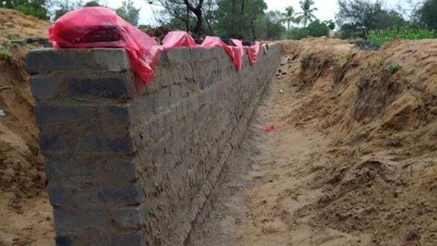 The wall that the Odisha government is building around a 1,700 hectare piece of land on Nuagaon village’s periphery to mark the inclusion of the land in the state government’s land bank, thereby restricting locals’ access to an area where they have traditionally harvested betel leaves, rice and fish. (Photo: IndiaSpend) The wall that the Odisha government is building around a 1,700 hectare piece of land on Nuagaon village’s periphery to mark the inclusion of the land in the state government’s land bank, thereby restricting locals’ access to an area where they have traditionally harvested betel leaves, rice and fish. (Photo: IndiaSpend)